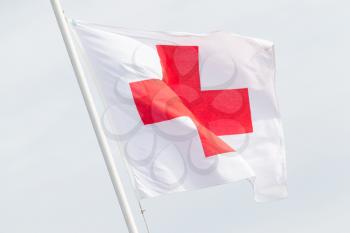 Red cross flag on top of an army tent