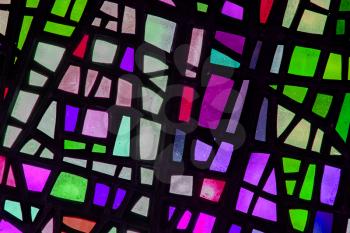 Image of a multicolored stained glass window with irregular block pattern