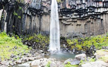 Svartifoss (Black Fall), Skaftafell, Iceland. Dramatic waterfall surrounded by dark basalt lava hexagonal columns