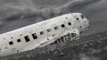 The abandoned wreck of a US military plane on Solheimasandur beach near Vik, Southern Iceland - Stormy clouds