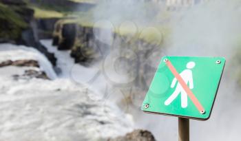 Forbidden to walk over here - Sign in Iceland - Fierce waterfall in background