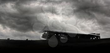 The abandoned wreck of a US military plane on Solheimasandur beach near Vik, Southern Iceland - Stormy clouds