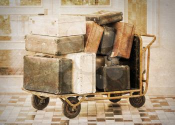 Trolley full of old luggage, vintage setting