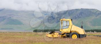 Road roller working in a field in Iceland