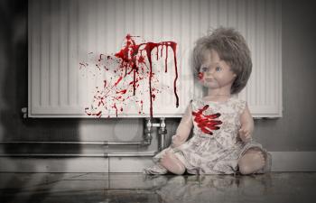 Concept of child abuse - Bloody doll, vintage