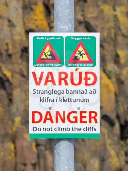 Sign in Iceland to warn for dangerous cliffs, selective focus