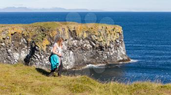 Woman on the edge of the cliff - Westcoast of Iceland
