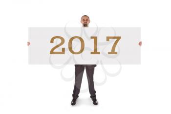 Smiling businessman holding a really big blank card - 2017, isolated on white