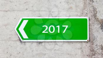 Green sign on a concrete wall - New year - 2017