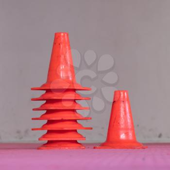 Interior of a gym, stack of red cones