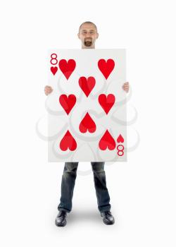 Businessman with large playing card - Eight of hearts