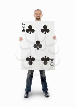 Businessman with large playing card - Five of clubs
