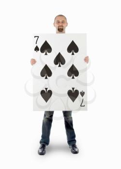 Businessman with large playing card - Seven of spades
