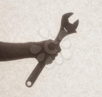 Silhouette behind a transparent paper - English wrench