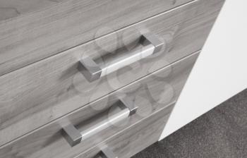 Modern cupboard with drawers, selective focus, metal handles