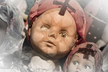 Scary white doll face, very old and broken