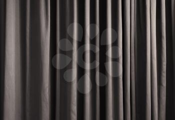 Close-up of closed curtain with light spots in a theater
