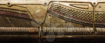Inside of a piano, dusty and scratched, vintage