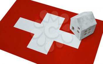 Small house on a flag - Living or migrating to Switzerland