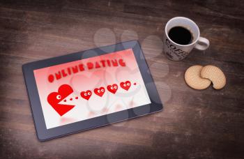 Online dating on a tablet - concept of love, red