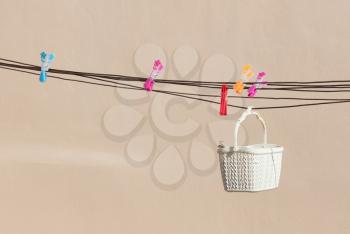 Simple white basket with clothespins, doing the loundry