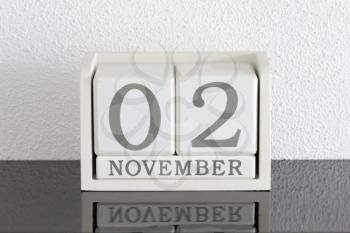 White block calendar present date 3 and month November on white wall background