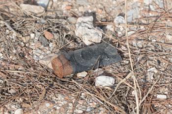 Rusty used shotgun shell on the ground