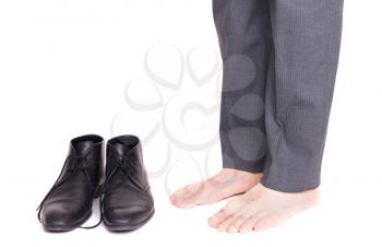 Businessman standing next to his shoes - Isolated