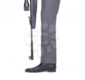 Concept - Businessman shooting himself in the foot with a rifle