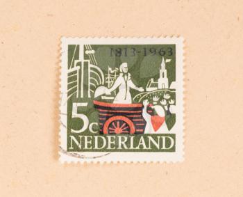 THE NETHERLANDS 1960: A stamp printed in the Netherlands shows a man in a boat, circa 1960