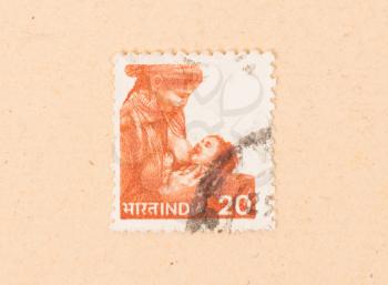 INDIA - CIRCA 1970: A stamp printed in India shows a woman breastfeeding a child, circa 1970