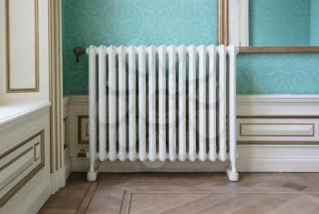 Old vintage heating radiator with valve, selective focus