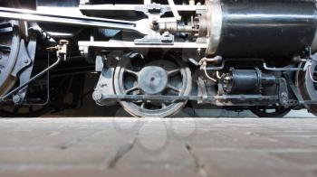 Steam locomotive wheels or steam train wheels and rods closeup for background