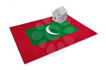 Small house on a flag - Living or migrating to Maldives
