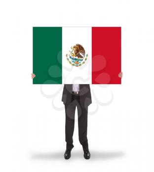 Businessman holding a big card, flag of Mexico, isolated on white