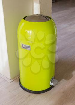 Green trash can in a dutch house
