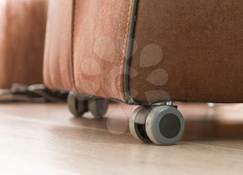 Leather dining room chair with wheels - Dirty and used - Selective focus