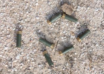 Rusty used shotgun shells on the ground