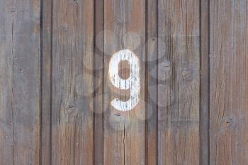 Number 9 written on a wooden door