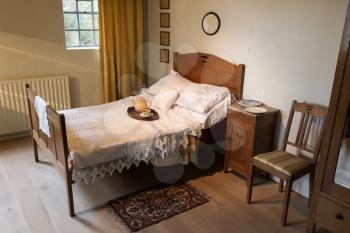 Very old double bed in a furnished bedroom - The Netherlands