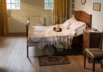Very old double bed in a furnished bedroom - The Netherlands
