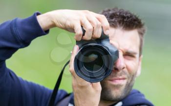Close up of a male photographer taking picture