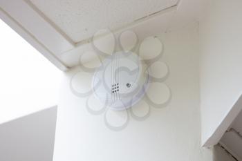 Smoke detector hanging on a ceiling - Private home