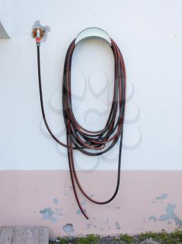 Garden hose hanging on a wall - Austria