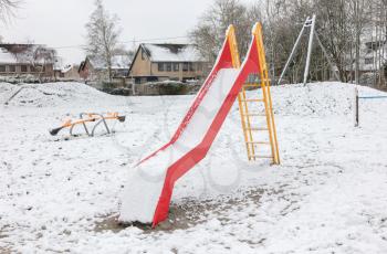 Playground in kindergarten for children in winter with snow - Slide