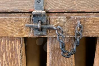 Close up of rusty slide locked wooden door