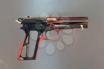 Used black metal 9mm pistol gun on solid background - Half gun