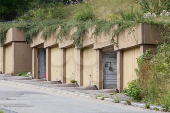 Doors of garages on a hill, empty street