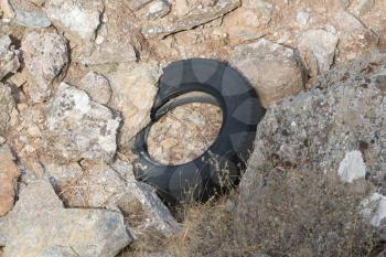 Pollution in Greece - Rubber tire left in nature