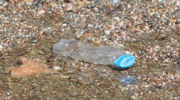 Plastic bottle on the beach - Pollution in Greece